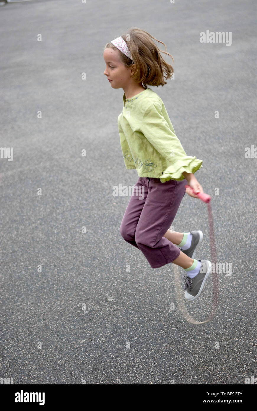 Child playing skipping / jump rope Stock Photo - Alamy