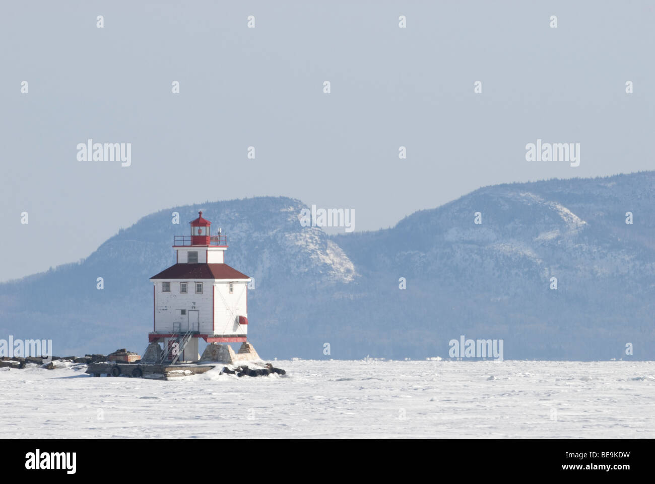 The frozen lake with a lighthouse Stock Photo
