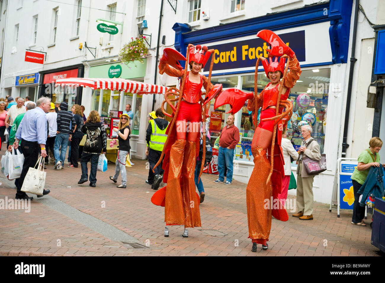 Stilt walking street performance artists dressed as lobsters at