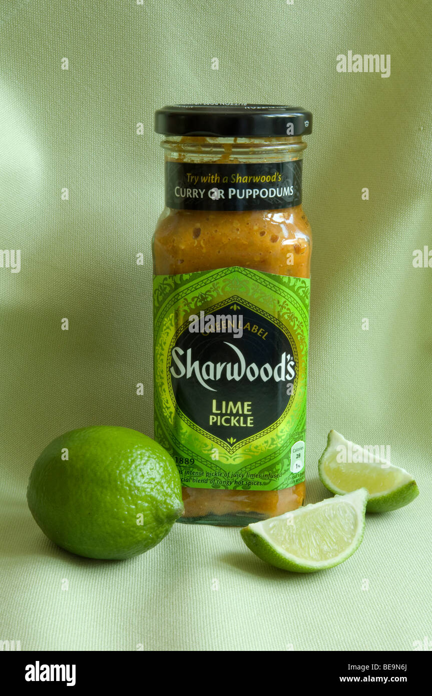 A jar of Lime Pickle, with Limes. Lime pickle is a popular