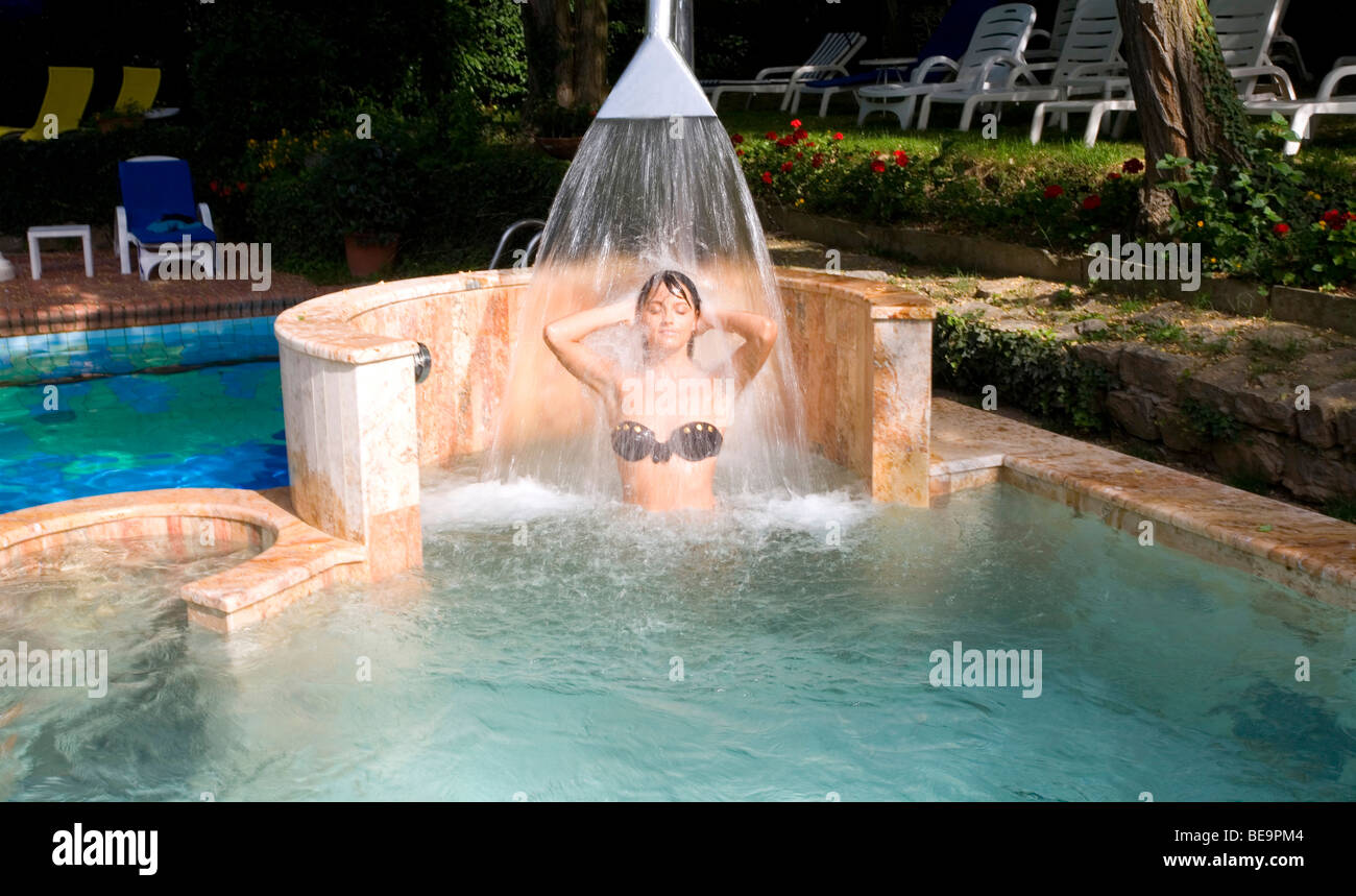 A Woman under a swimming pool shower at the Hotel Astoria in Montecatini Terme, Tuscany, Italy Stock Photo