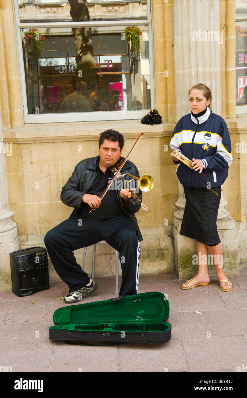 Busker playing Romanian horn violin on shopping street in city centre of Cardiff South Wales UK Stock Photo