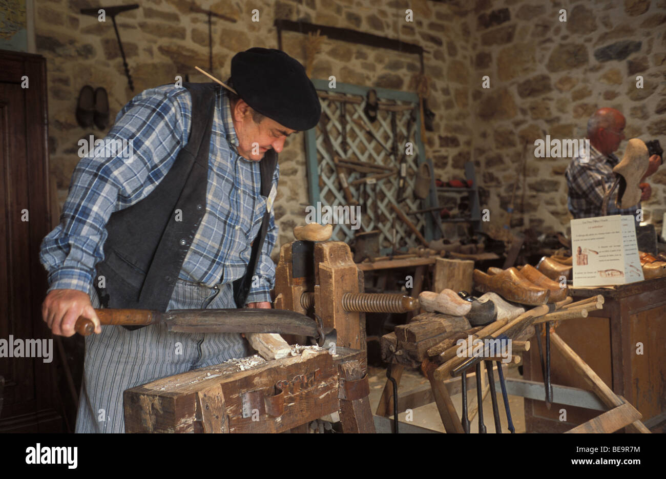 A clog or wooden shoe maker demonstrates his art at Argol museum in Finistere Brittany France Stock Photo