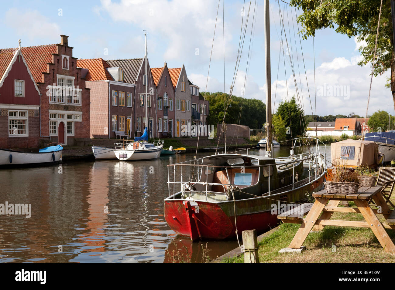 Edam canal houses picnic table by the water. Noord Holland, the Netherlands Stock Photo