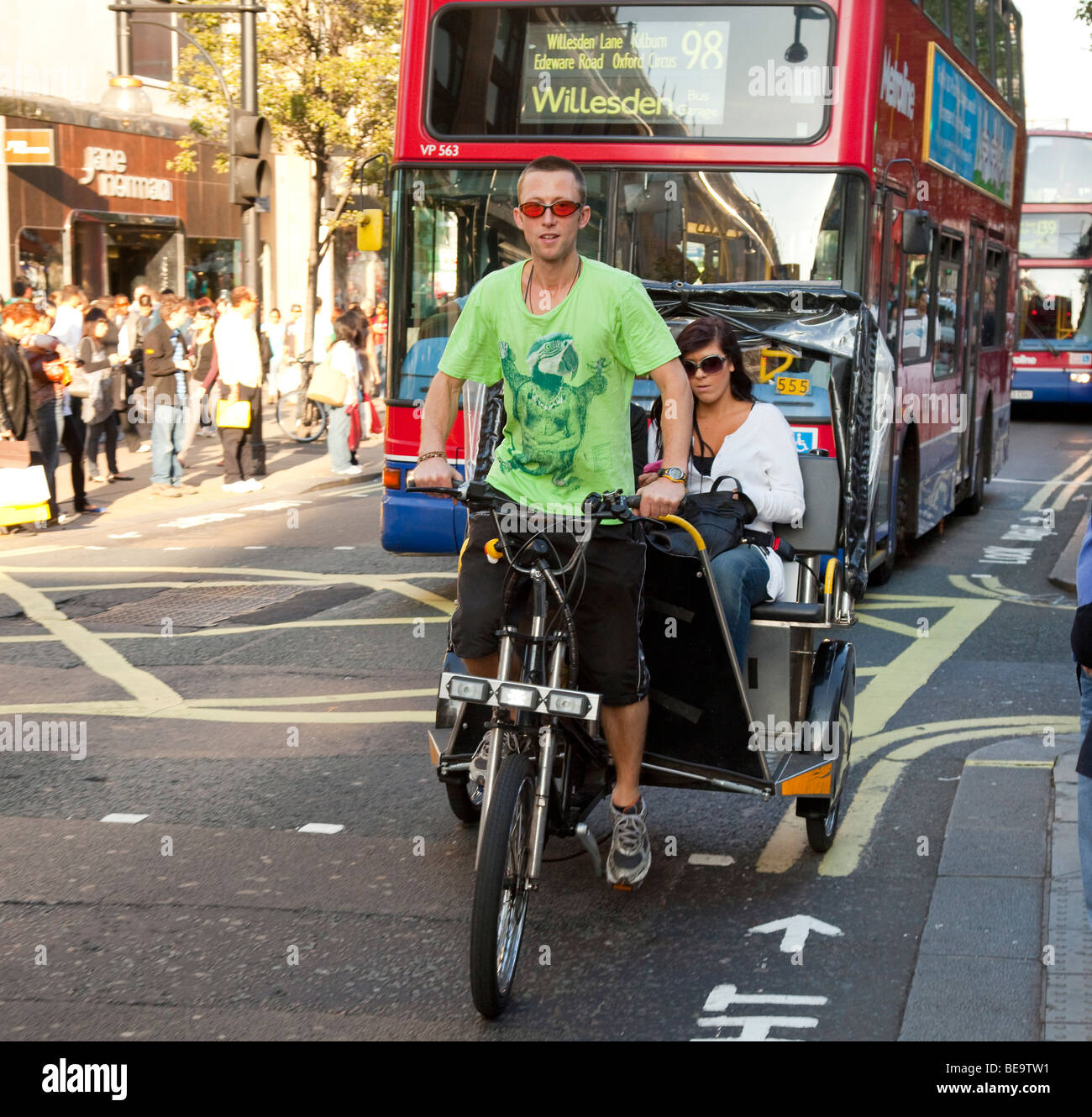 Riding in a Pedal 'Rickshaw' taxi trike in Oxford Street , London Stock Photo