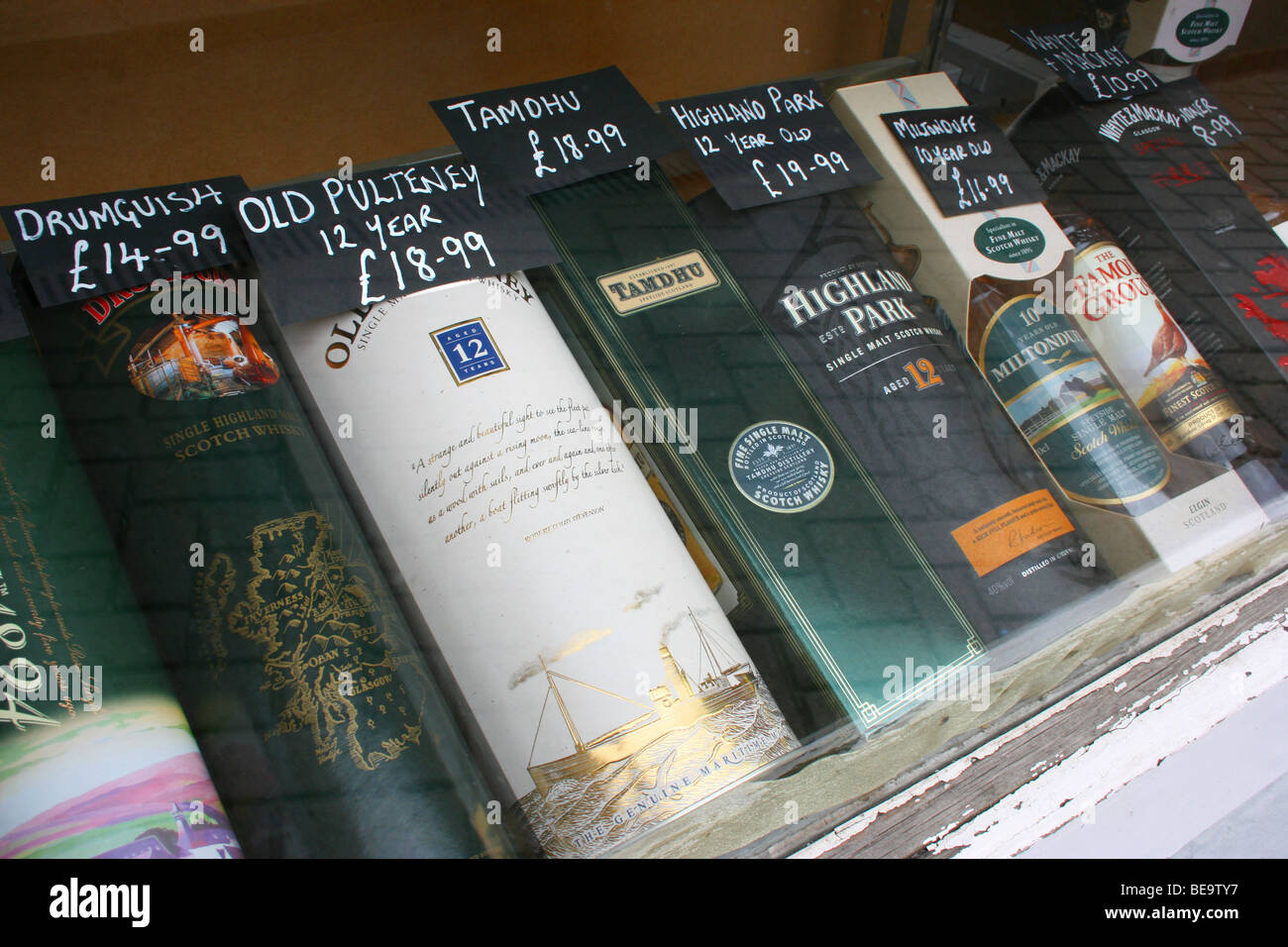 range of Scottish Whiskies on display in the window of an offlicense