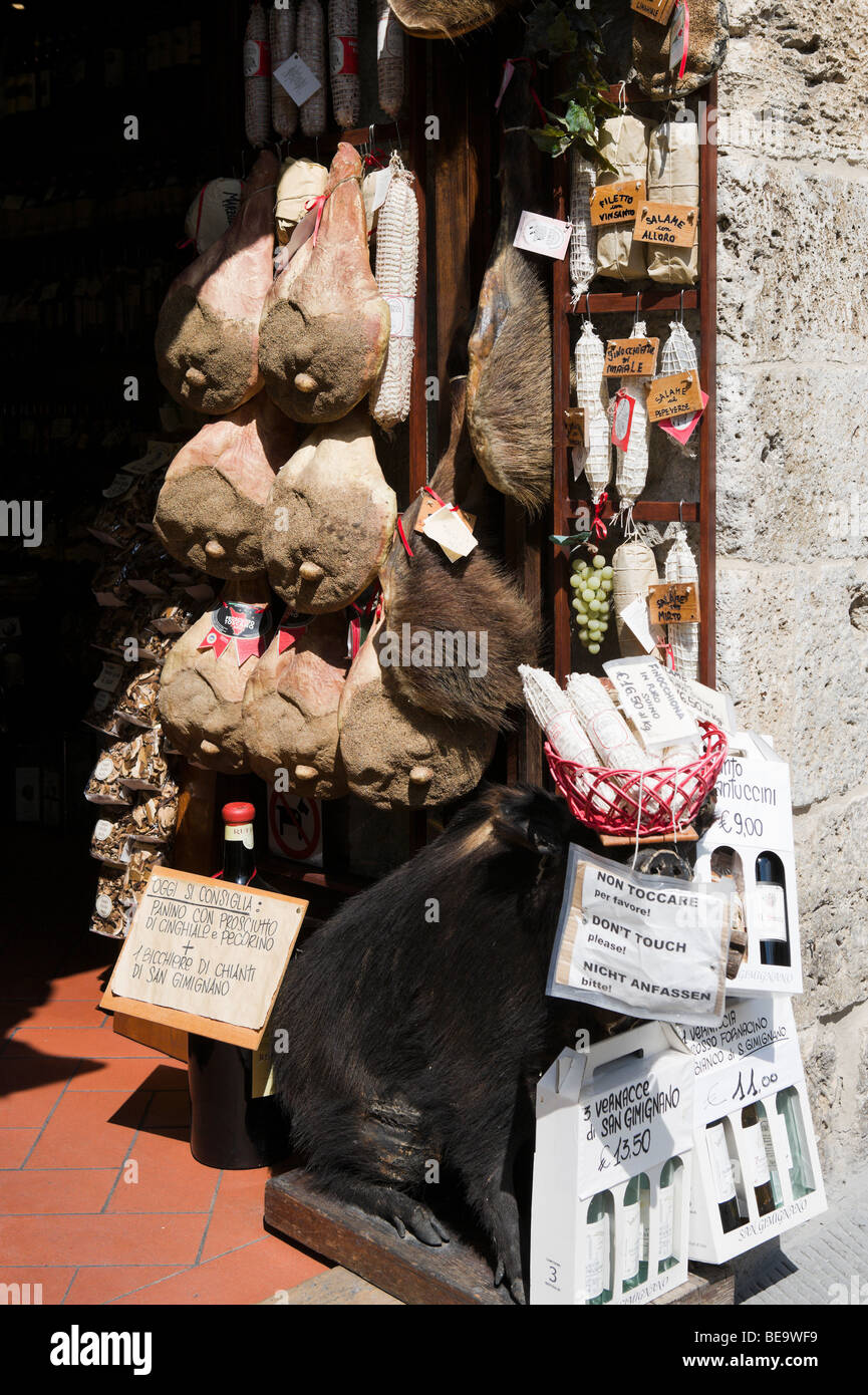 Shop selling local wine and wild boar products in the old town, San Gimignano, Tuscany, Italy Stock Photo