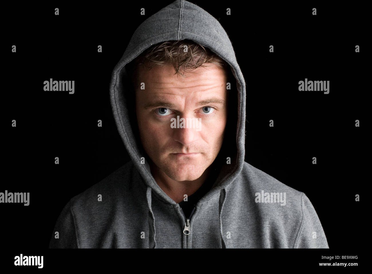 A hooded man looking at the camera Stock Photo