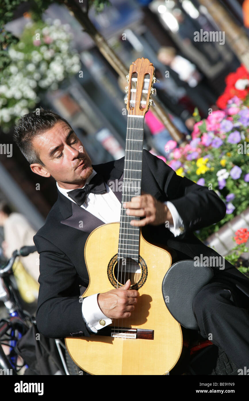 Town of Congleton, England. The classical guitarist Kevin Wain playing in Congleton Town Centre at Bridge Street. Stock Photo