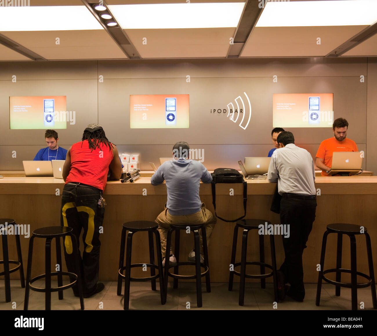 customers at iPod bar at Apple store, Regent Street, London, England, UK Stock Photo