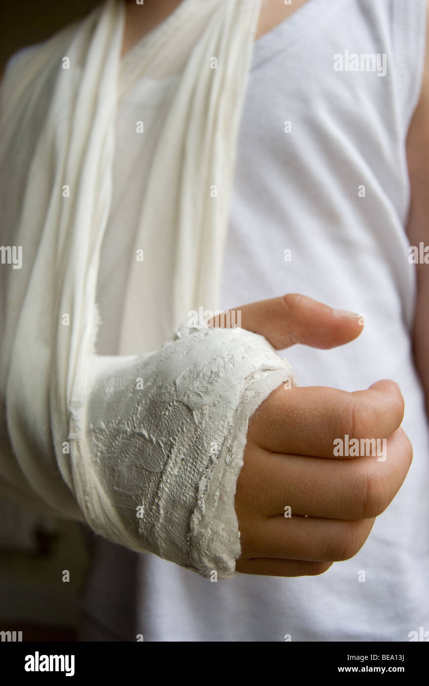Child's arm in plaster and sling Stock Photo