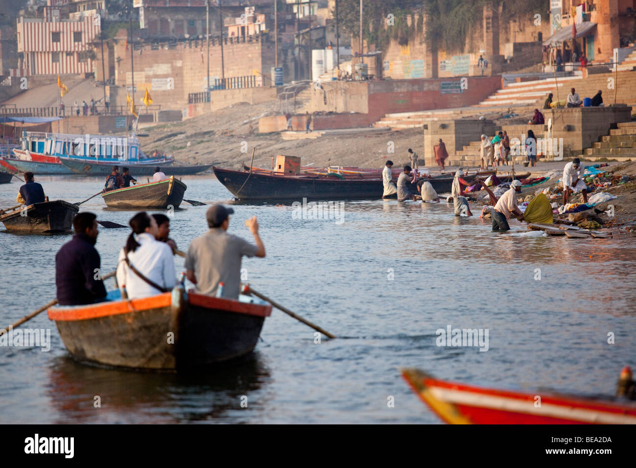 Boat of Tourists watching clothes washing in the Ganges River in Varanasi India Stock Photo