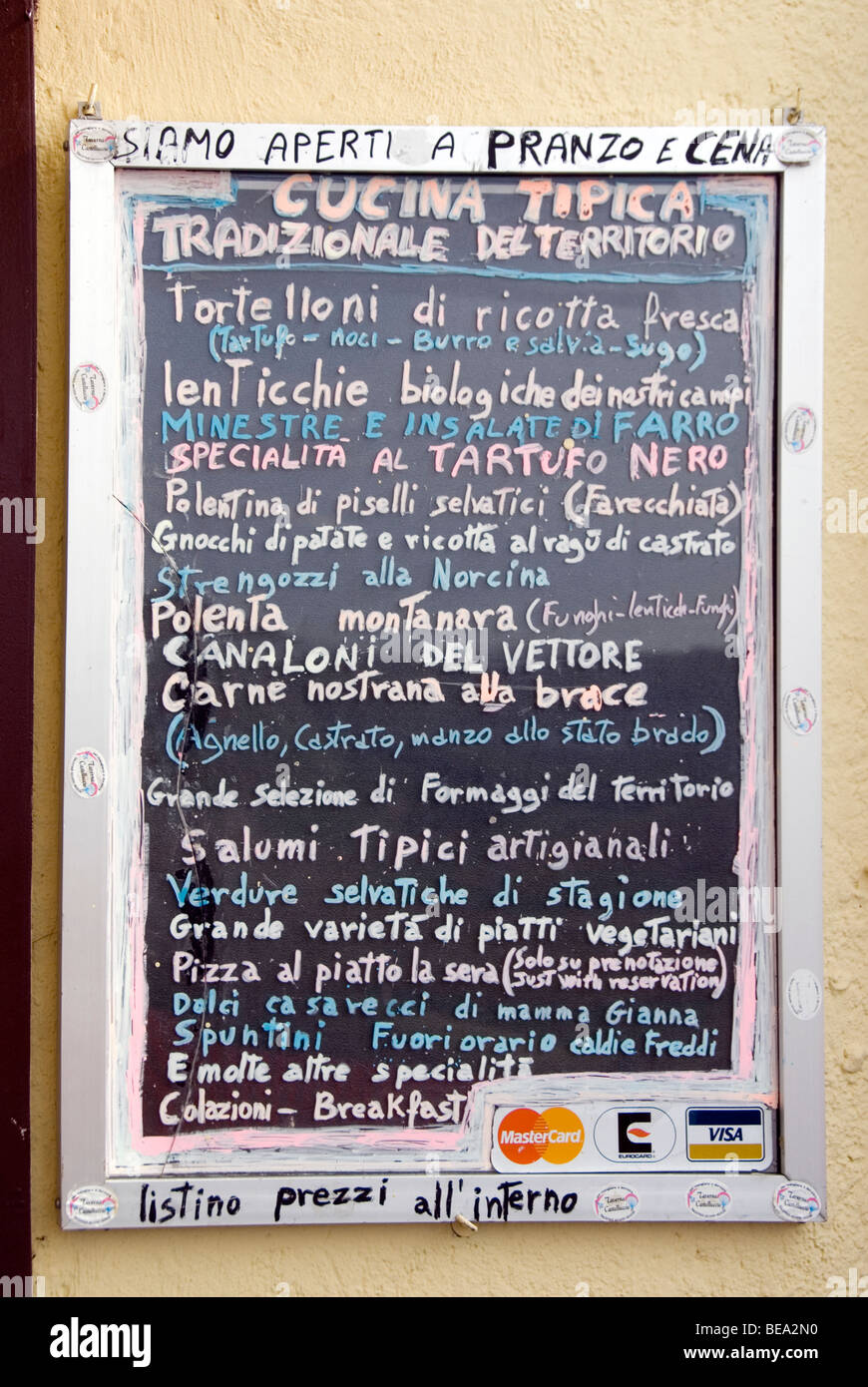 Rustic menu board with typical local dishes outside a restaurant in Castelluccio in Umbria Stock Photo