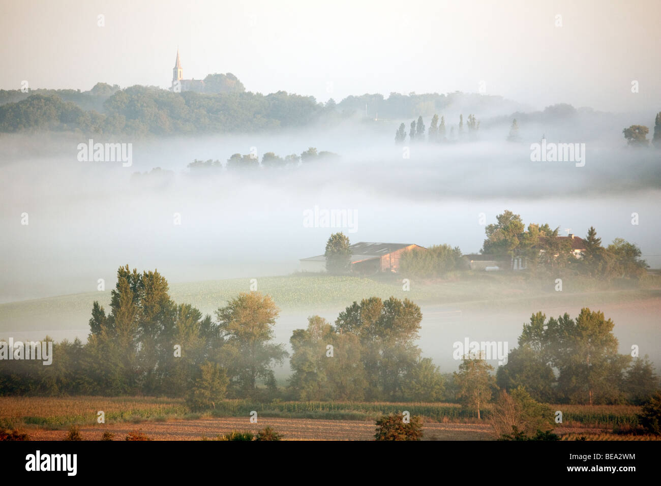 A misty dawn and sunrise in the Lot valley near Castelmoron, Aquitaine countryside, France, Europe Stock Photo