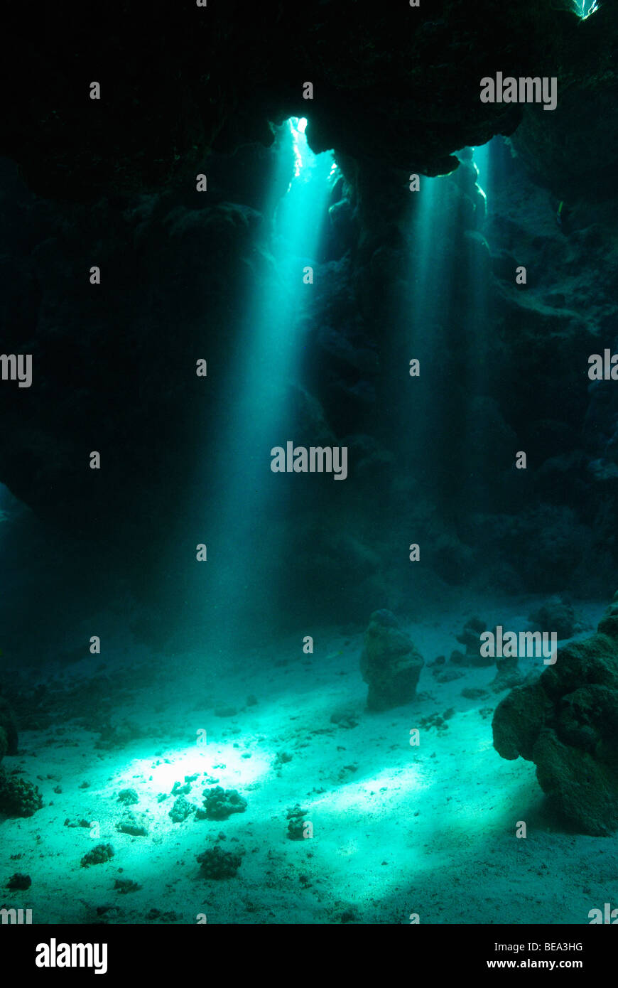 Rays of light stream inside an underwater cave, Red Sea Stock Photo