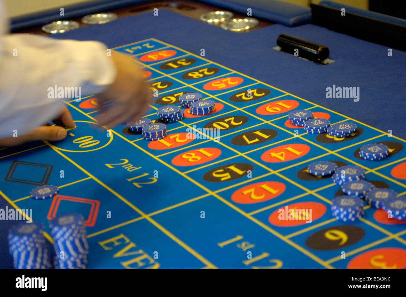 Placing betting chips on the numbers of roulette table Stock Photo Alamy