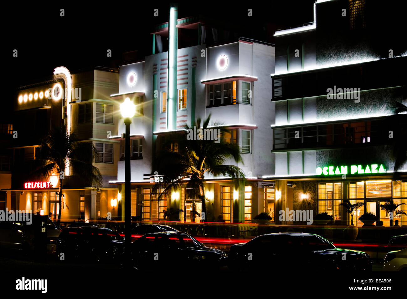 The Mc Alpin Hotel, The Crescent Hotel and the Ocean Plaza Hotel lit up at night in neon. South Beach Art Deco District Miami Fl Stock Photo
