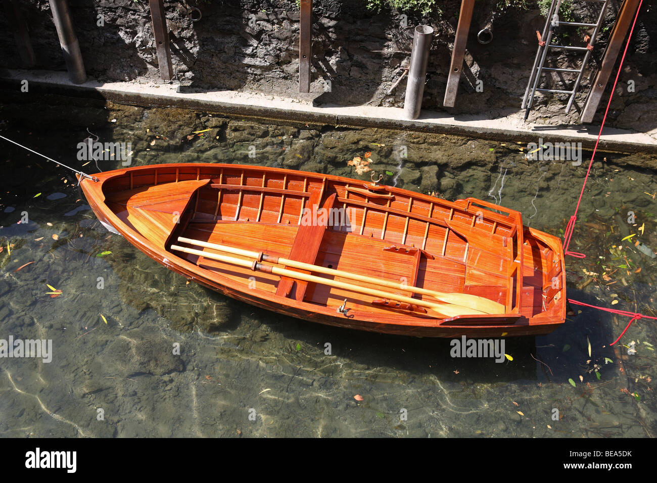 Wooden rowing boat with oars moored at Varenna on Lake Como, Italy, Europe Stock Photo