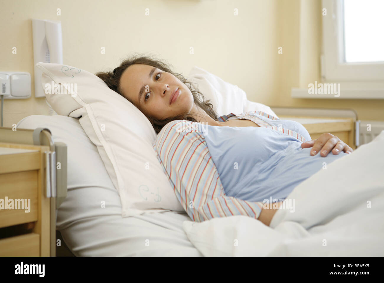 Young pregnant woman lying in hospital bed Stock Photo Alamy