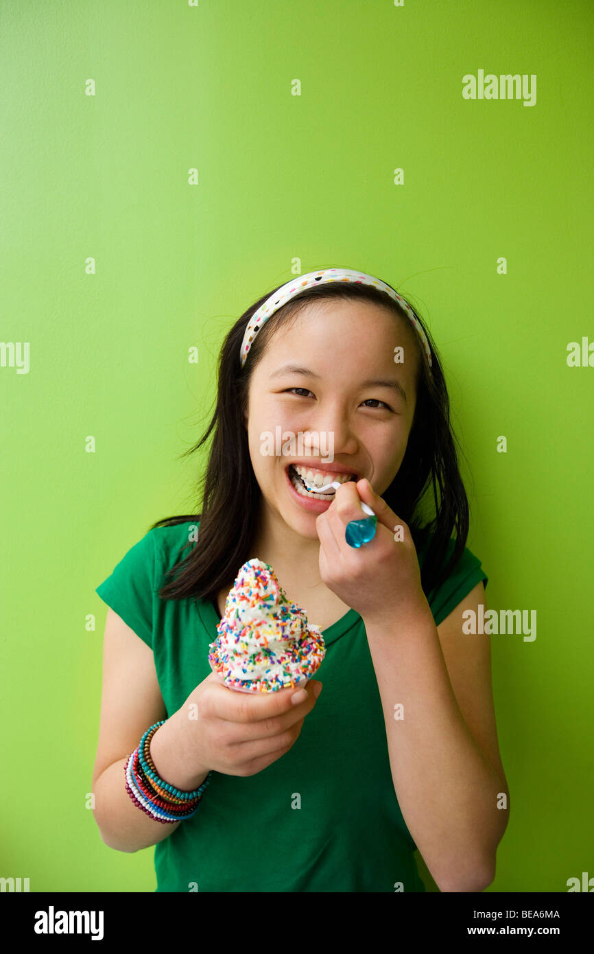 Chinese girl eating ice cream with sprinkles Stock Photo Alamy