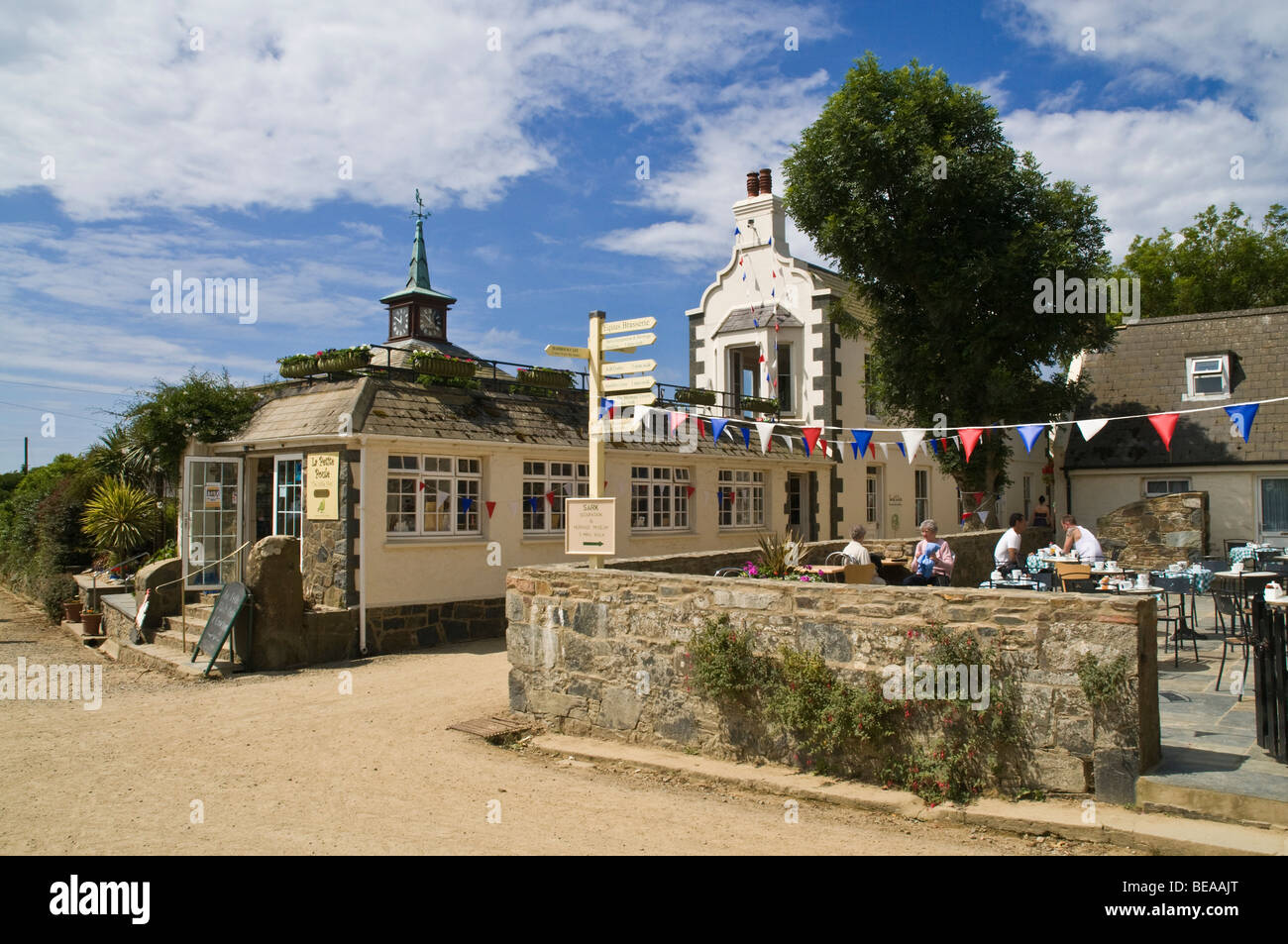 dh  SARK VILLAGE SARK ISLAND Village tourist cafe customers relaxing outdoors and main street buildings Stock Photo