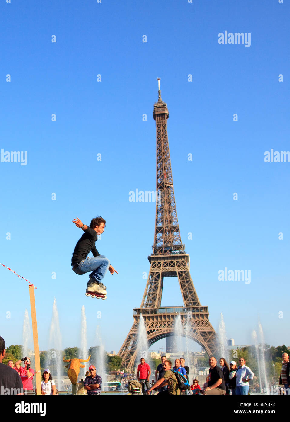 Roller Skater jumping in front of the Eiffel Tower Paris Stock Photo