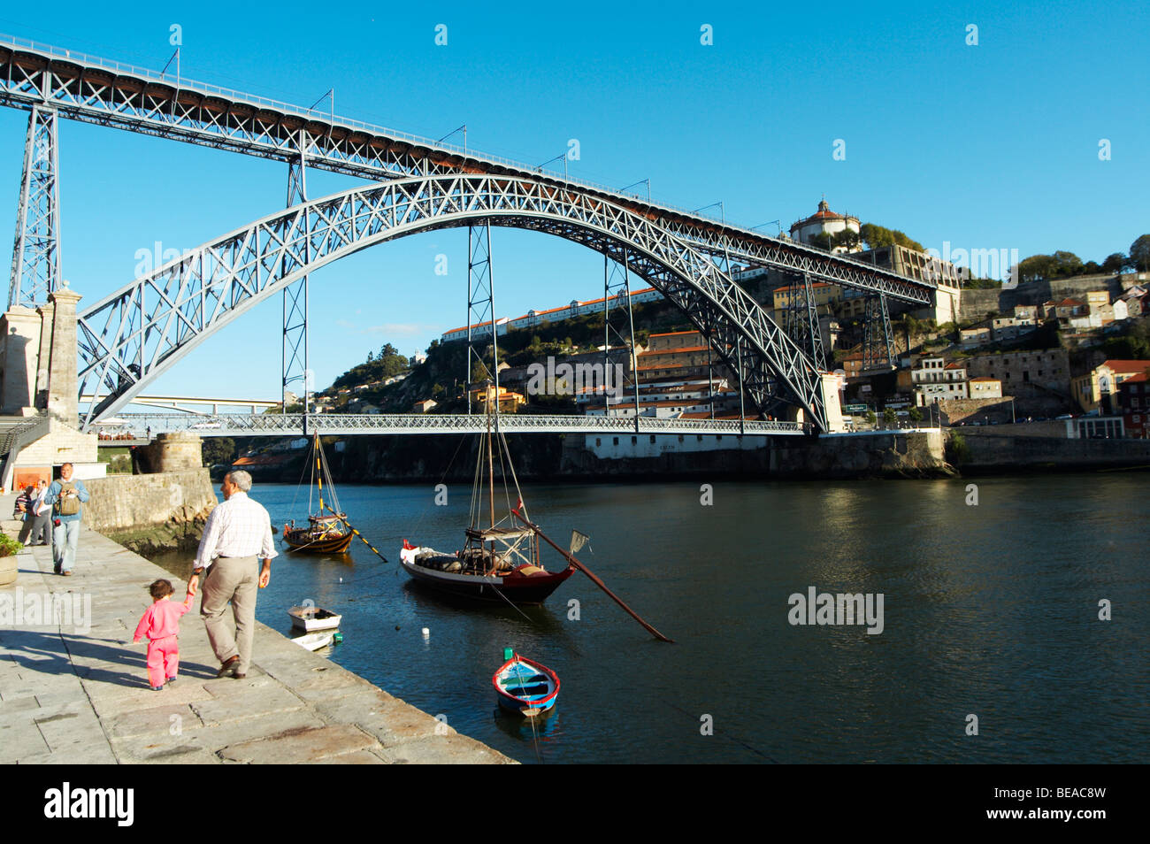 Dom Luis I bridge seen from Cais da Ribeira barco rabelo shipping boat porto portugal Stock Photo
