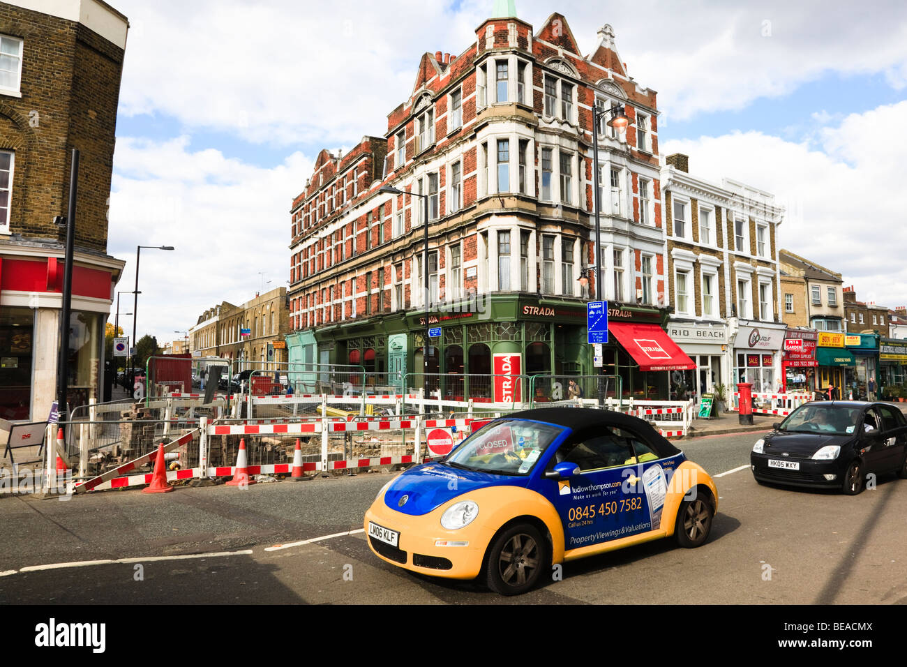 Yellow and Blue Volkswagen car in Clapham High Street, advertising an