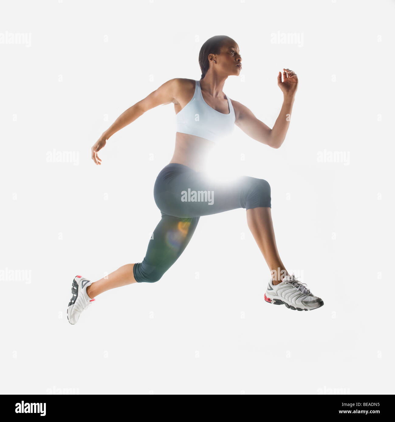 Mixed race woman jumping in mid-air Stock Photo