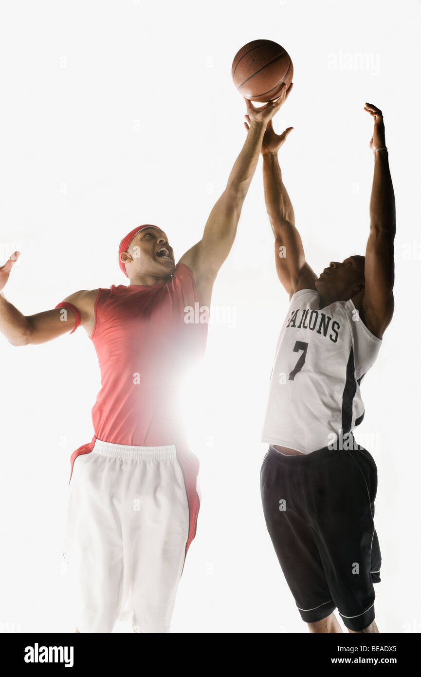 African men jumping for basketball Stock Photo