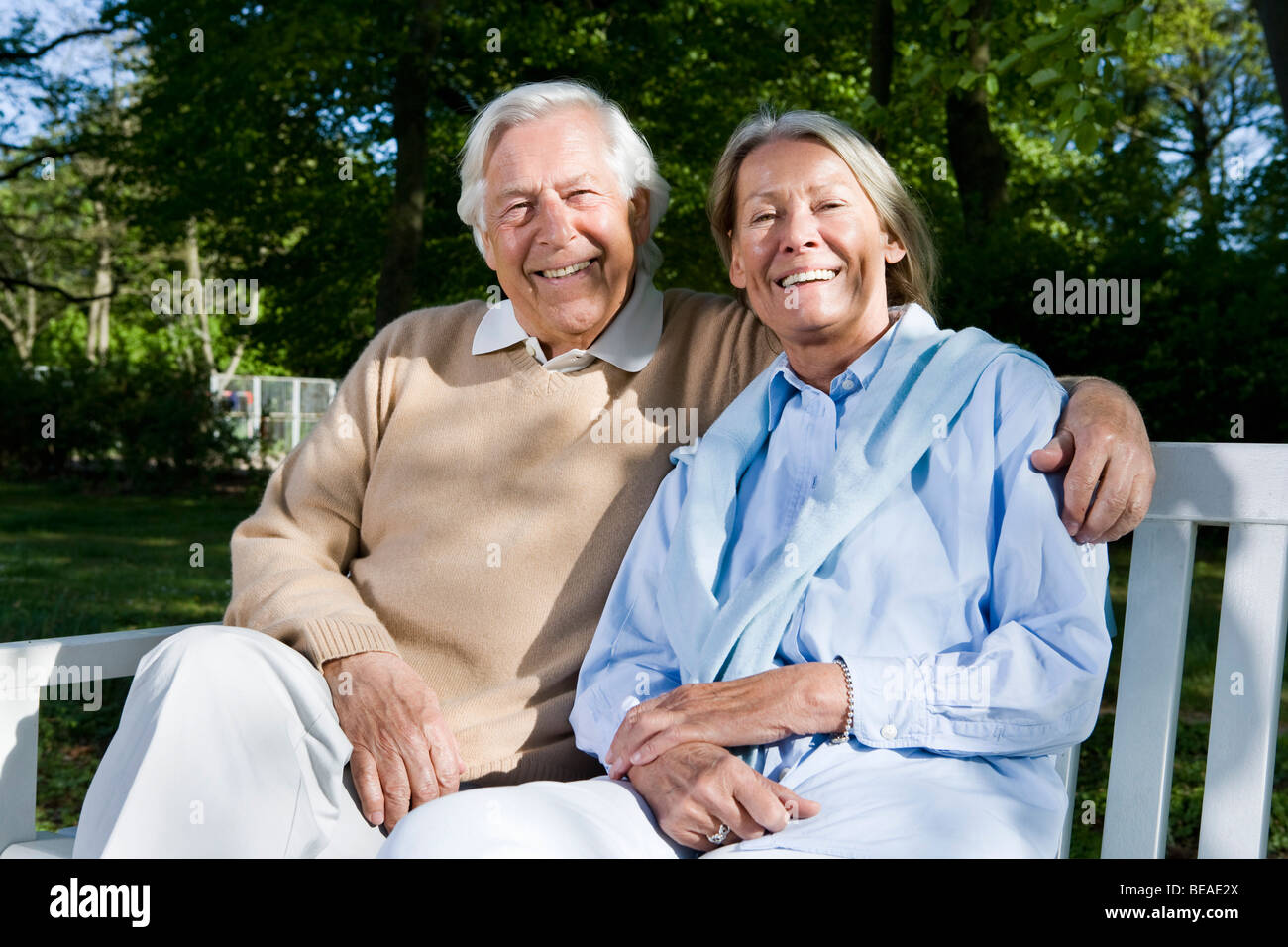 A senior couple sitting on a bench together Stock Photo - Alamy