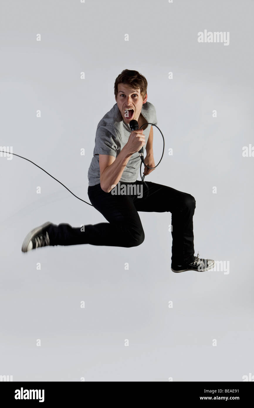 A singer jumping in mid-air Stock Photo