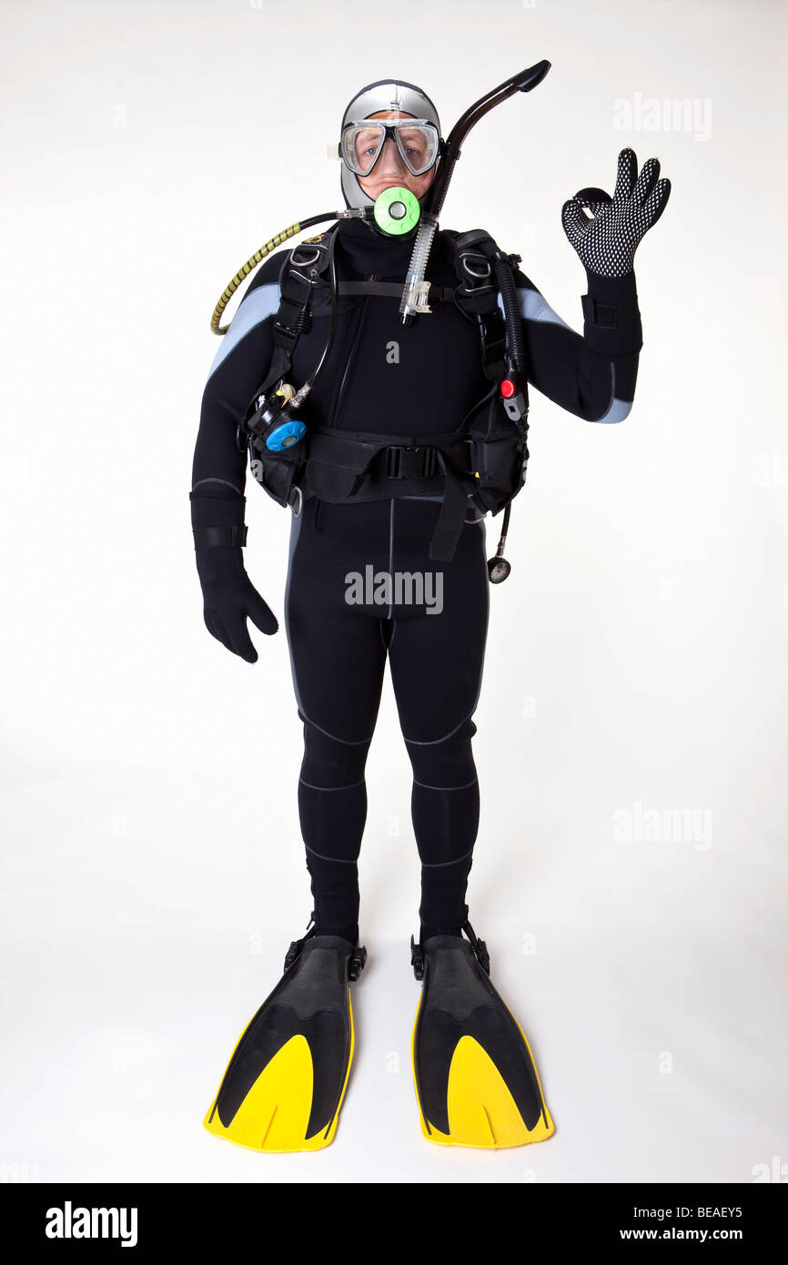 A scuba diver giving the OK sign, studio shot Stock Photo