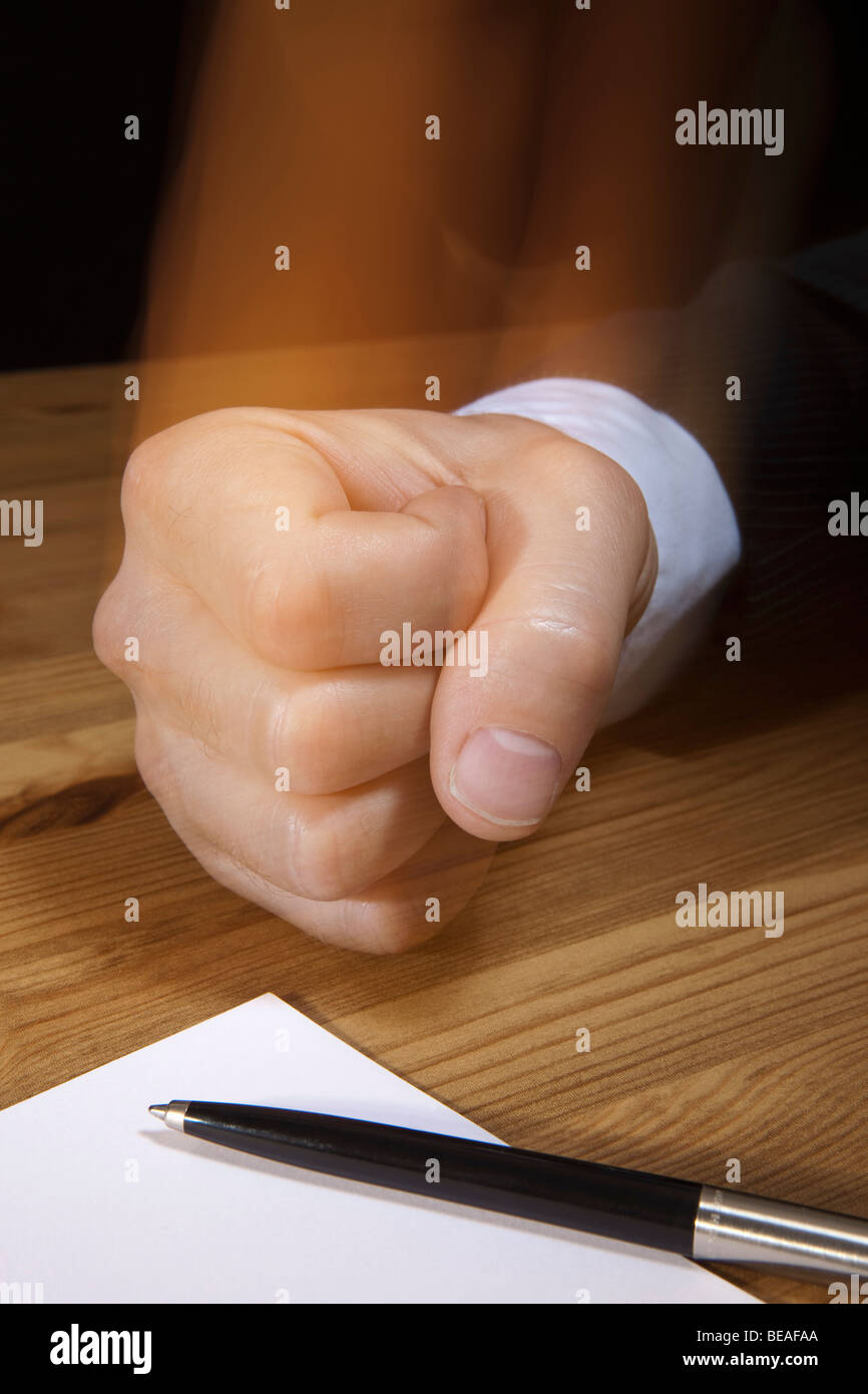 A fist pounding on a table Stock Photo Alamy