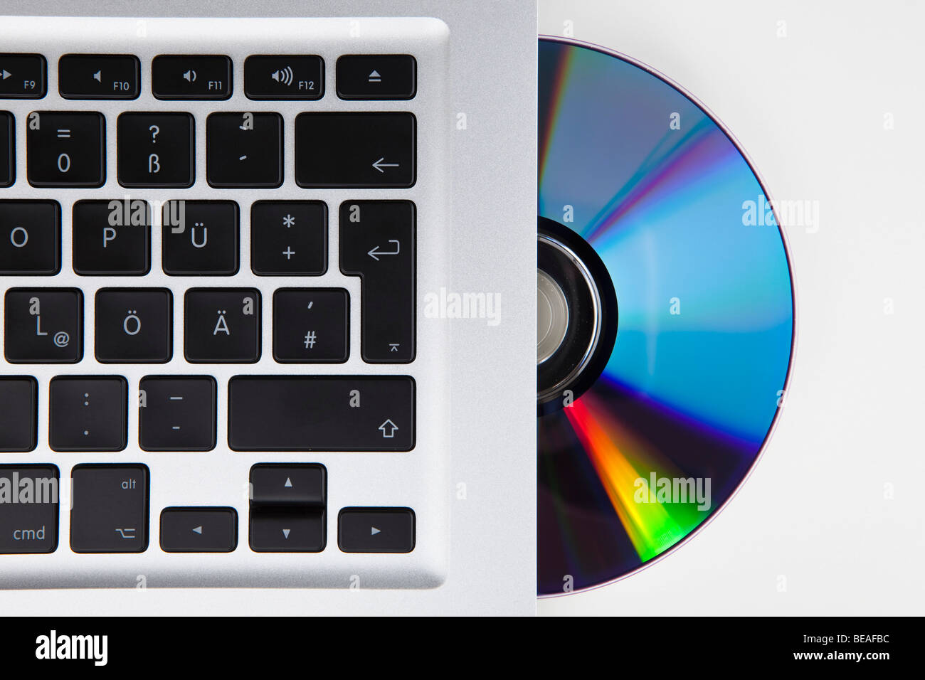 A CD-ROM or DVD halfway in a German laptop Stock Photo