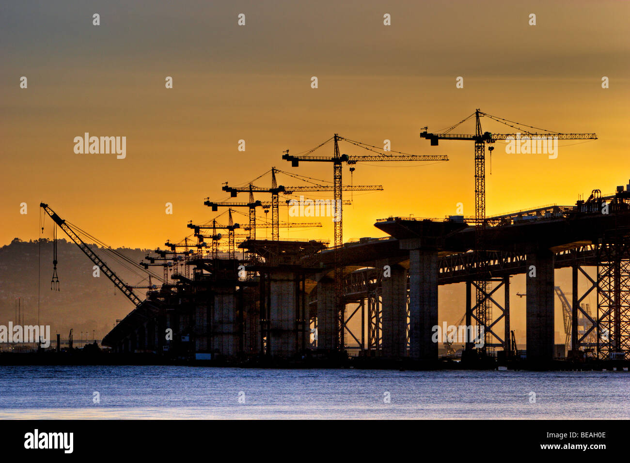 Cranes rise above the new eastern span of the Bay Bridge rises in the