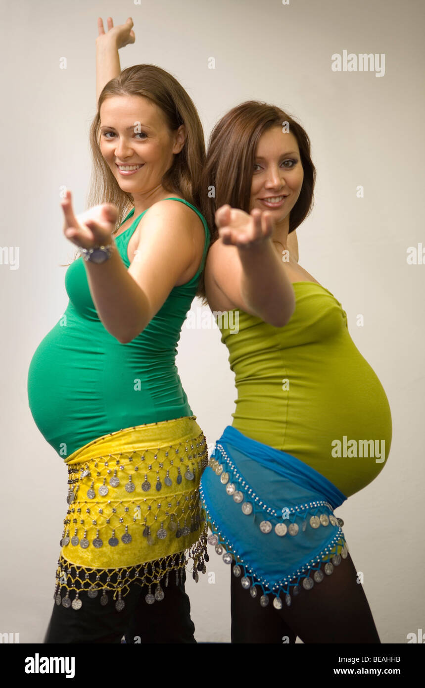 Pregnant women dancing belly dance. Stock Photo
