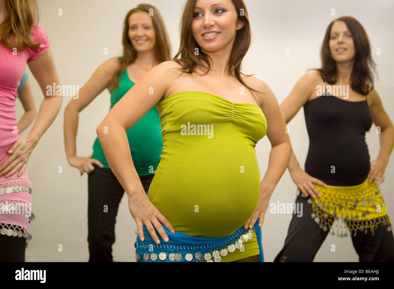 Pregnant women dancing belly dance. Stock Photo