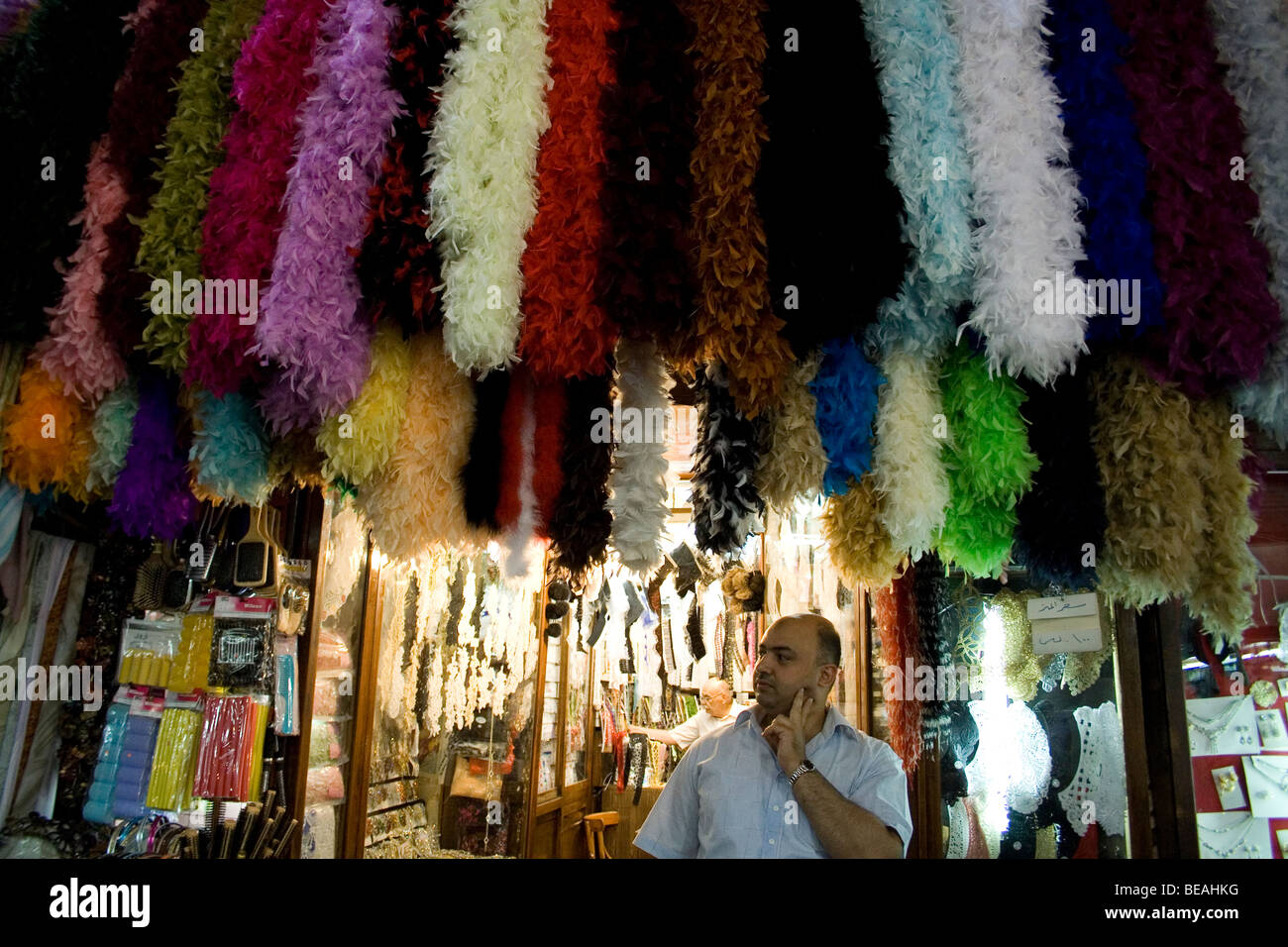 A man standing at his market stall thinking.  Old City market, Damascus Stock Photo