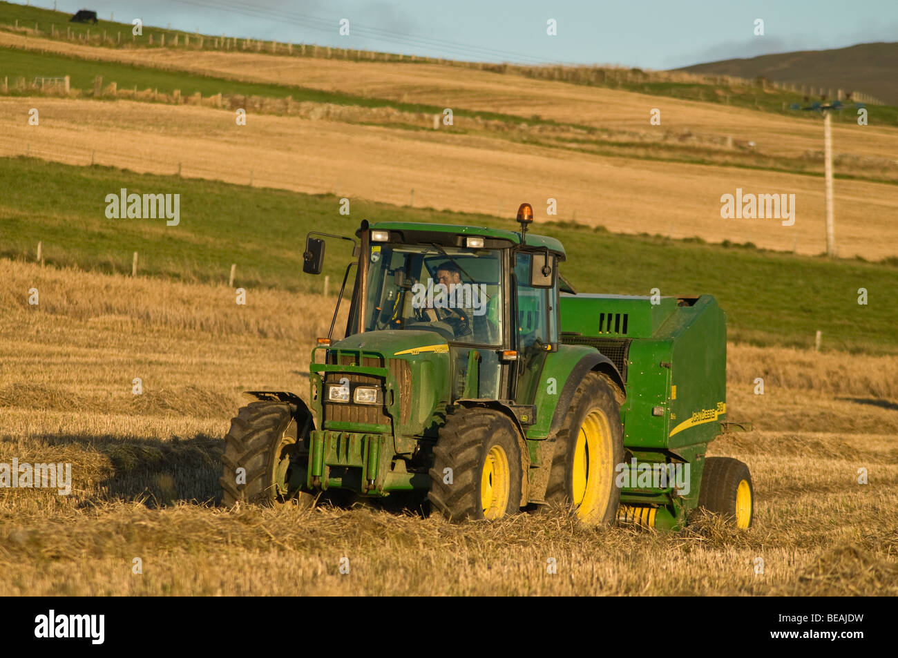 dh John Deere tractor baler HARVESTING UK Baling field hay bales agriculture harvest farming machine green farmer machinery tractors Stock Photo