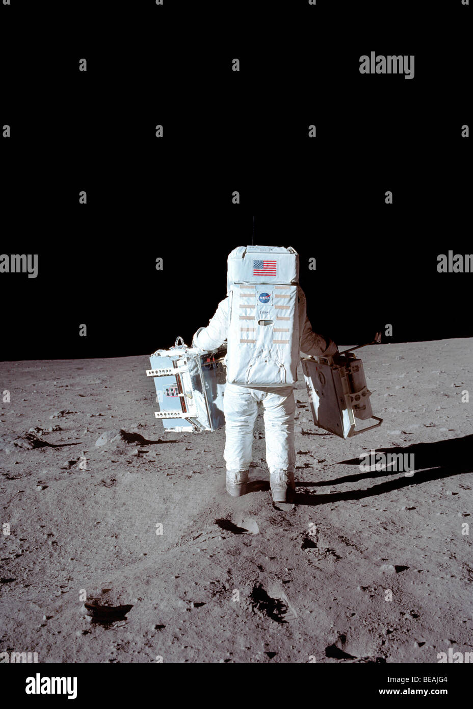 Buzz Aldrin on the moon carrying scientific equipment. Apollo 11. Optimised and enhanced version of a NASA image. Credit NASA. Stock Photo