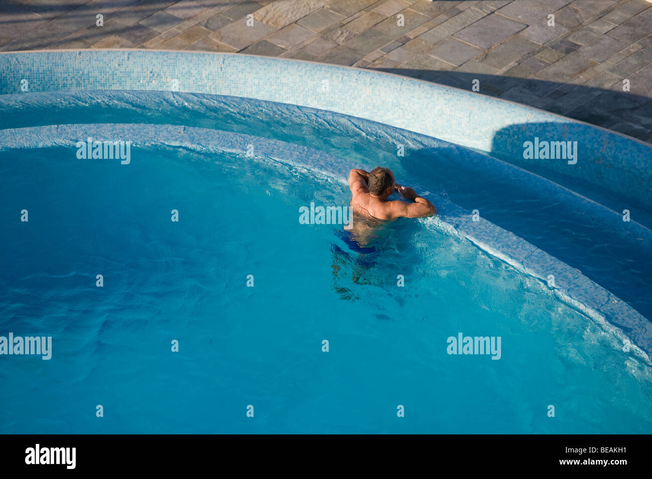 Man in swimming pool, resting and relaxing on the island of Crete. Greece. Stock Photo