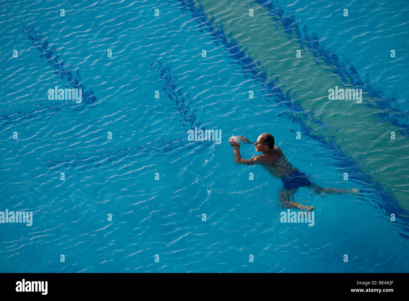 Man in swimming pool on the island of Crete. Greece. Stock Photo