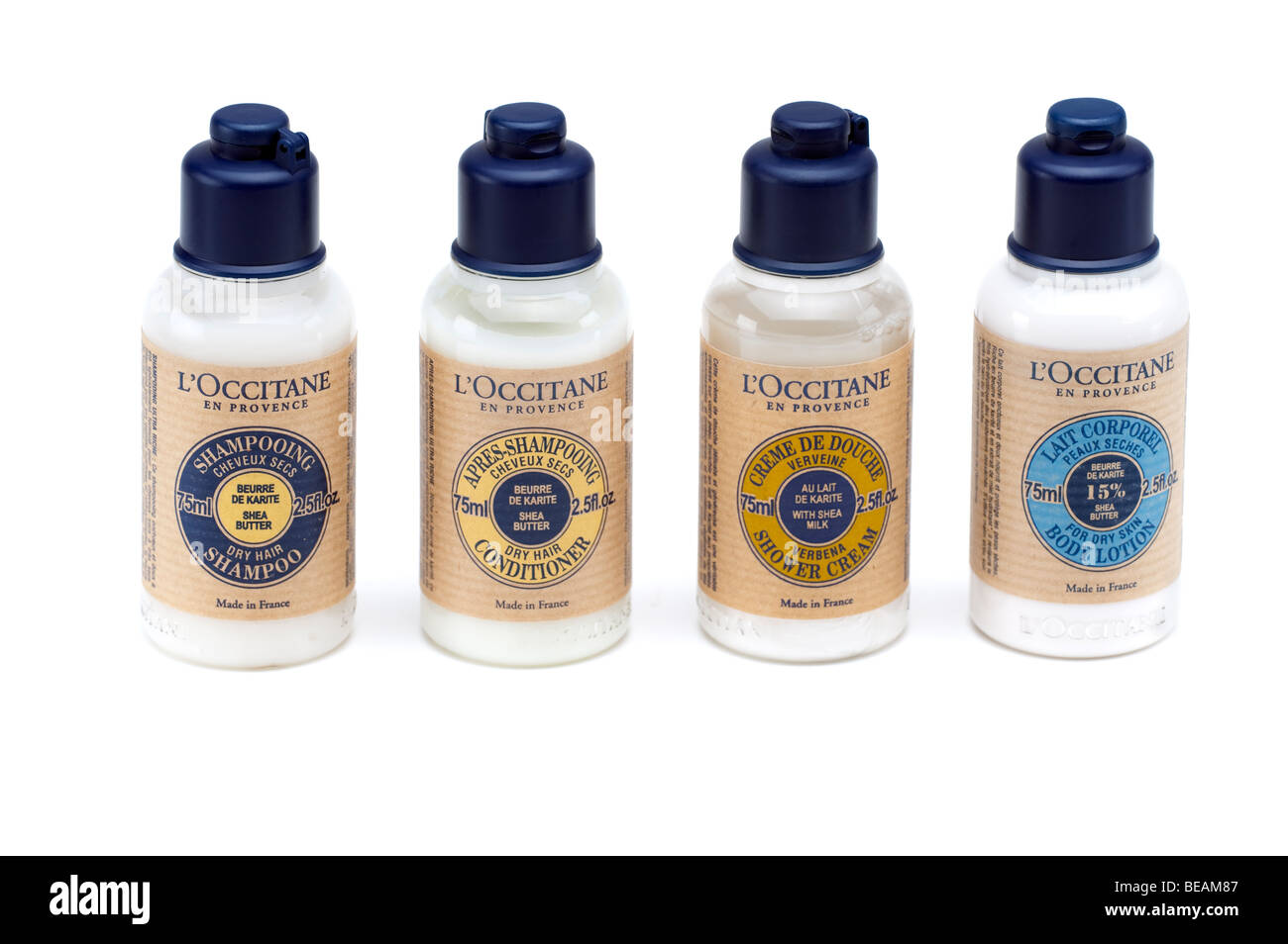 Four plastic bottles of one of each L'Occitane  Shampoo,conditioner,body lotion and shower cream Stock Photo