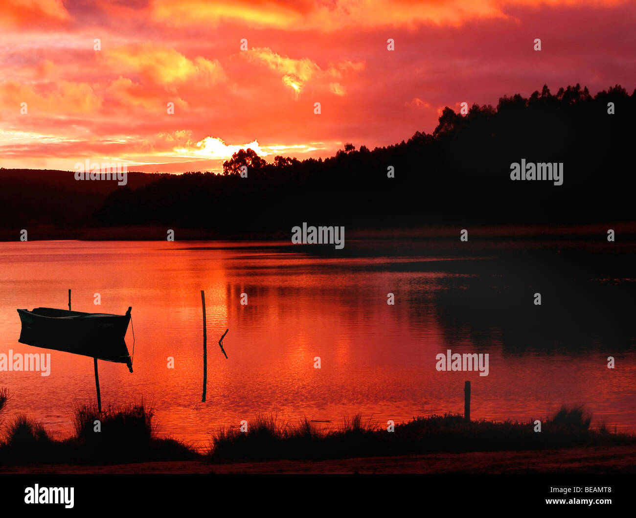 Sunset in the lake with a boat silhouette Stock Photo - Alamy