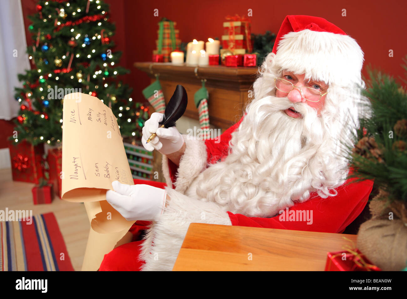 Santa Claus writing names on list Stock Photo