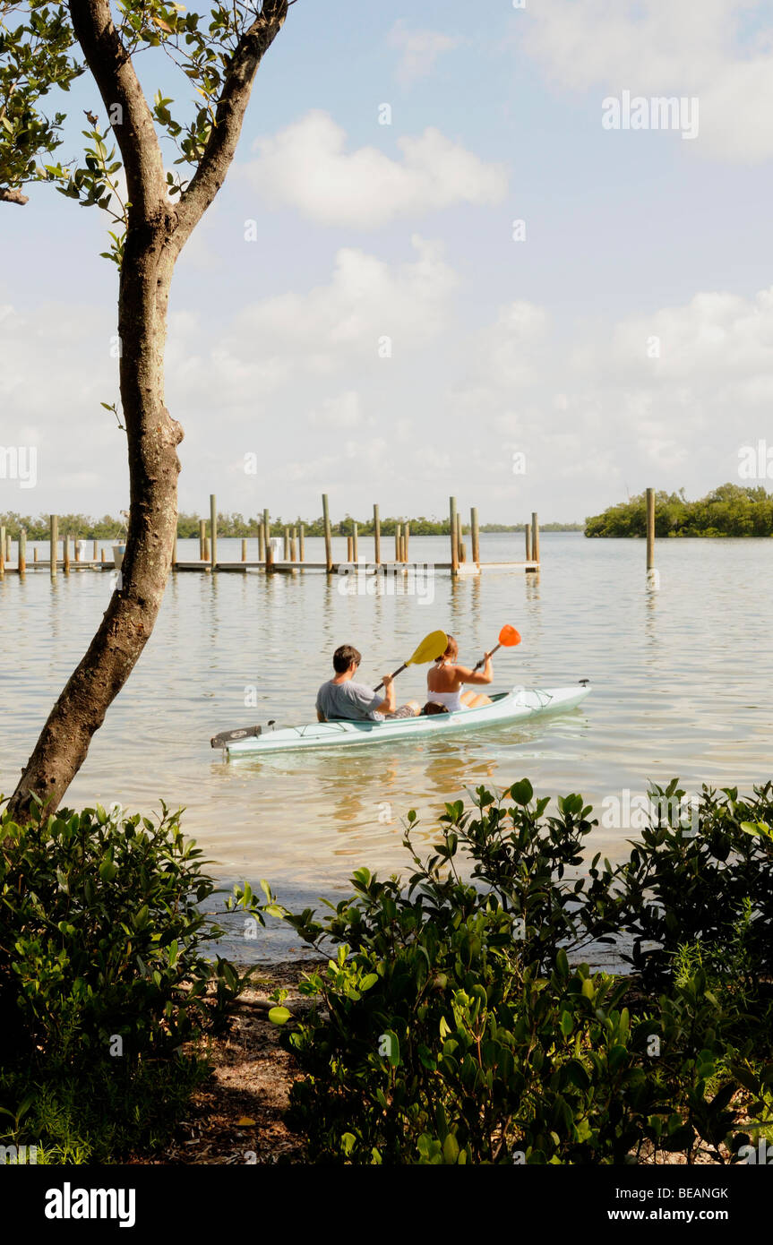 Kayakers in a double kayak paddle between islands in Pine Island Sound