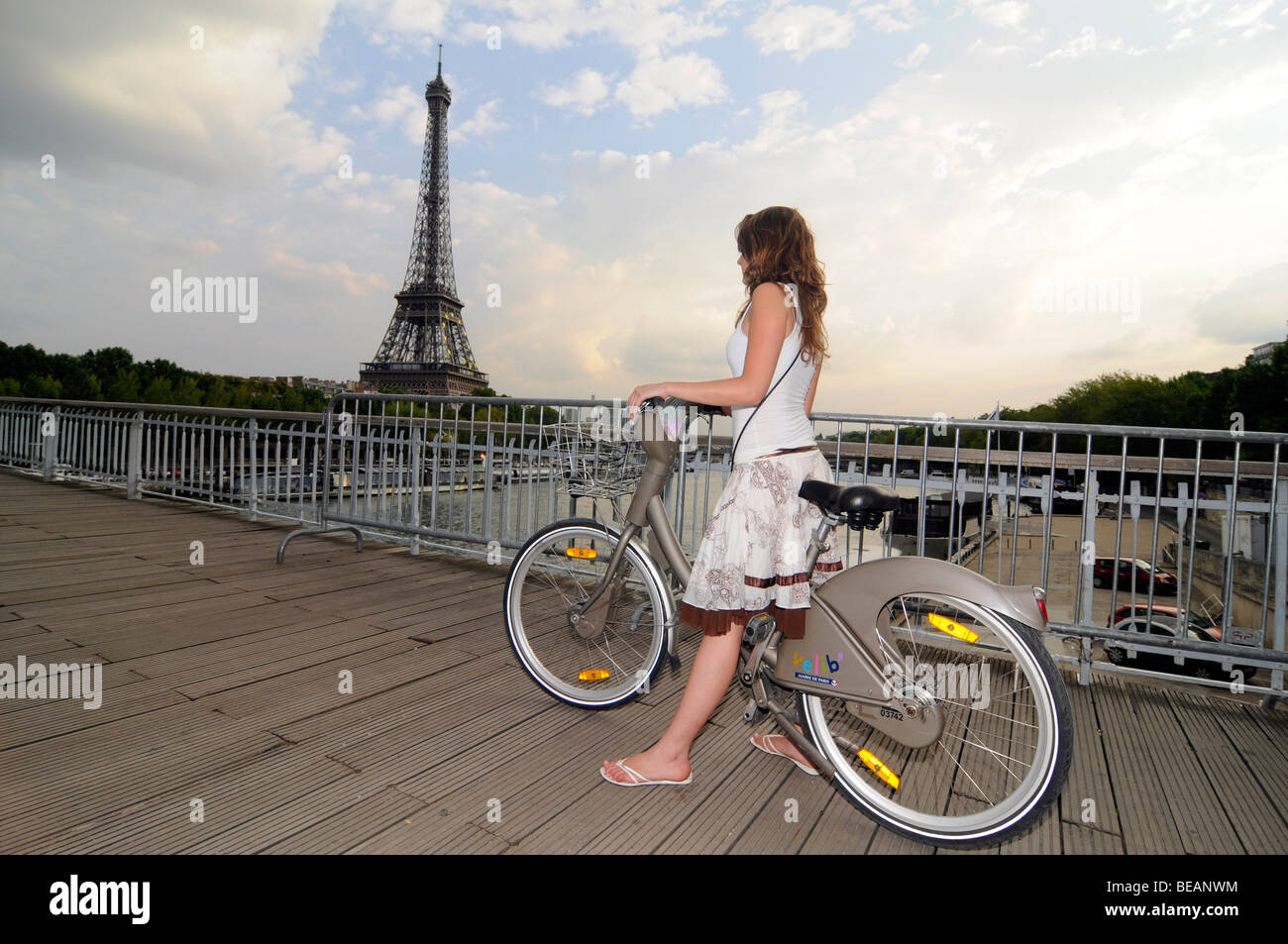 A French girl cycling on a rental "Velib" bicycle in central Paris