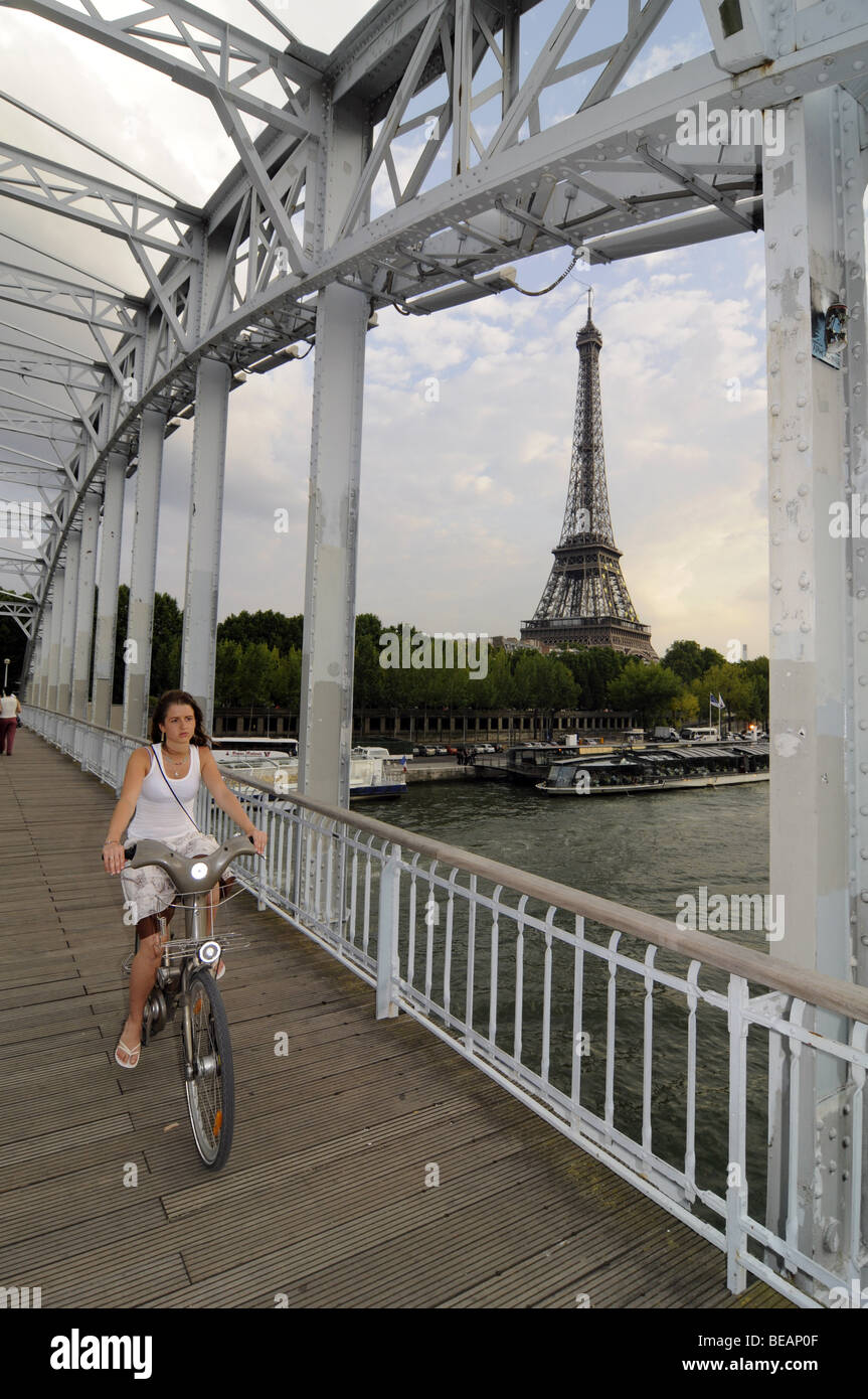A French girl cycling on a rental "Velib" bicycle in central Paris ...