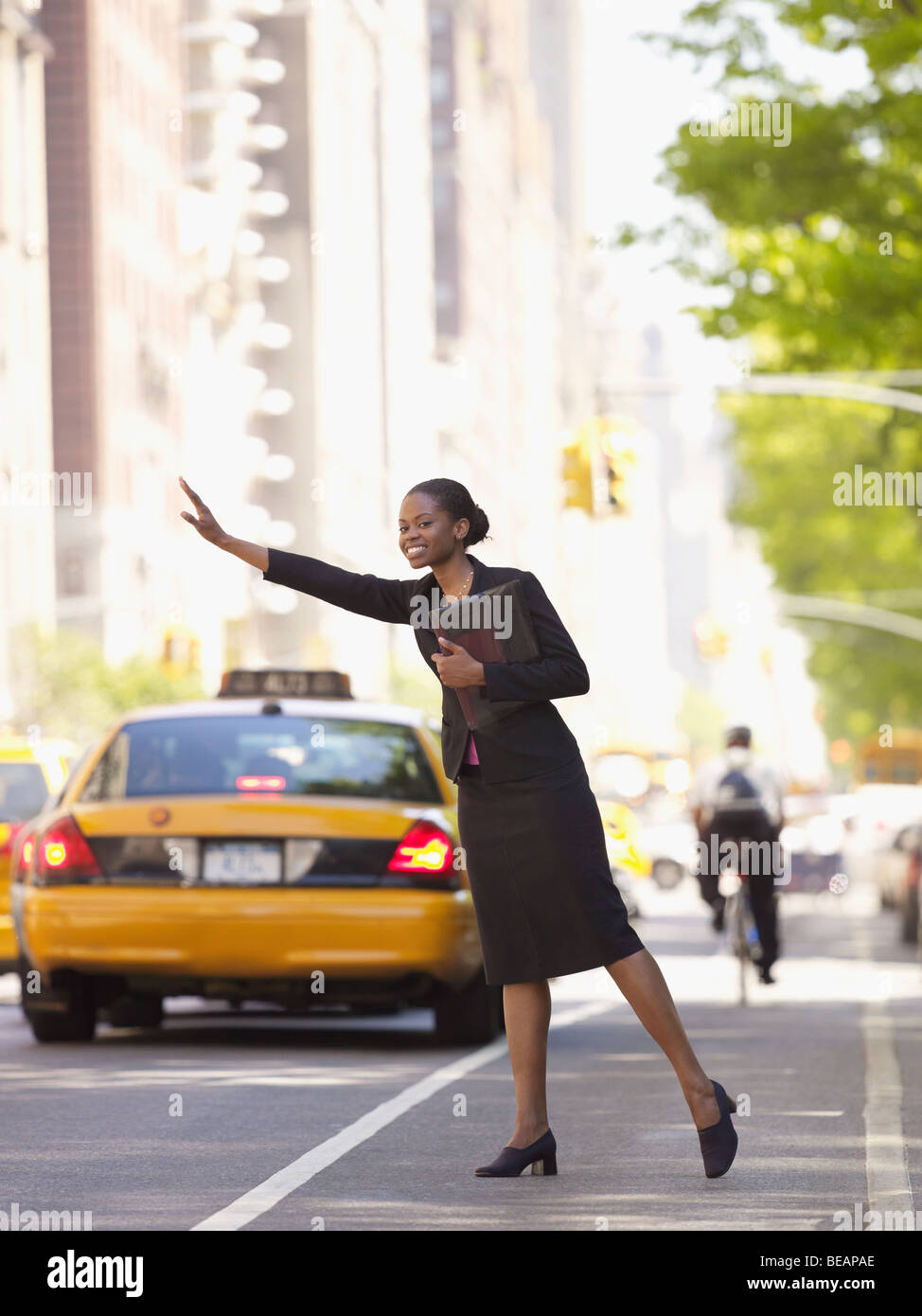 African businesswoman hailing taxi Stock Photo